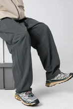 Man in mens plus size elastic waist pants with grey cargo style and sneakers