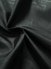 Black fabric with subtle gray geometric pattern on a plus size hooded windproof outdoor jacket