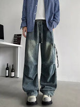 Men’s plus size loose fit cargo jeans in faded blue wide-leg denim with visible stitching and side pockets