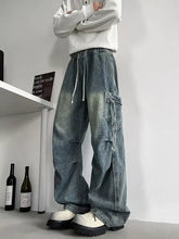 Men’s plus size loose fit cargo jeans in washed blue denim with drawstring waist and multiple practical pockets