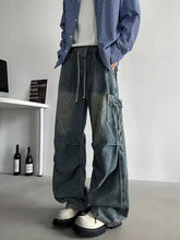 Men’s plus size loose fit cargo jeans in dark-wash denim with multiple pockets and a drawstring for comfort