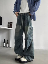 Men’s plus size loose fit cargo jeans in faded blue denim with wide-leg and multiple pockets for casual wear