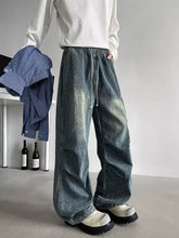 Men’s plus size loose fit cargo jeans in faded blue denim with wide-leg cut and visible stitching details