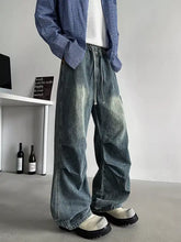 Men’s plus size loose fit cargo jeans in faded blue wide-leg denim with distressing and reinforced stitching