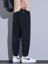 Men’s plus size loose fit black tapered jogger pants with drawstring waist and subtle side pockets for casual wear