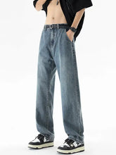 Men’s plus size loose fit light-wash denim jeans with a relaxed wide-leg cut and black belt visible from the front