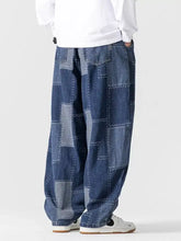 Men’s plus size blue denim patchwork wide leg jeans with relaxed fit and contrasting white stitching
