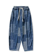 Men’s plus size blue patchwork denim wide leg jeans with white drawstring waistband and patchwork wide leg design
