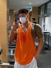 Muscular man in mens plus size round neck racerback orange tank top, basic style