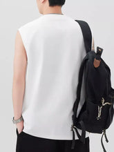 Black canvas backpack with brown leather accents and drawstring pockets paired with plus size round neck tank