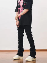 Men’s plus size slim fit black distressed denim jeans with frayed hem and ruffled details at the cuffs