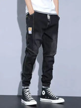 Men’s plus size slim fit wash jeans in black denim joggers with contrasting white stitching and thigh patch