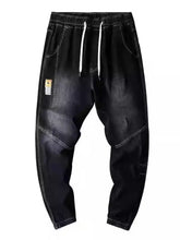Men’s plus size slim fit wash jeans in black denim joggers with white drawstrings and contrasting stitching