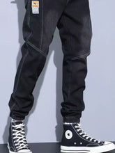 Men’s plus size slim fit wash jeans in black denim joggers with white stitching elastic cuffs and branded thigh patch