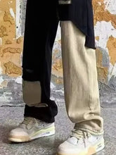 Beige and white air jordan 4 sneakers with visible branding paired with men’s plus size two-tone ripped wide-leg jeans