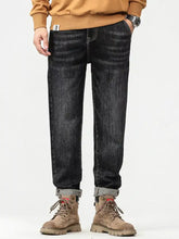 Men’s plus size dark-wash denim jeans with vintage wash texture and rolled cuffs featuring a relaxed fit design