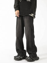 Men’s plus size black wide leg denim pants with vintage wash distressed faded finish and visible seam stitching