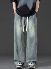 Men’s plus size vintage wash wide leg jeans in light-wash denim with white drawstrings and diagonal seam detailing