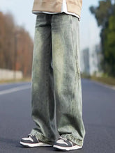 Men’s plus size vintage wash wide leg jeans in faded greenish-blue denim with subtle distressing and frayed hems