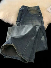 Men’s plus size vintage wash wide leg jeans in faded blue denim with subtle distressing and raw hem detailing