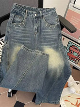 A men’s plus size vintage wash wide leg jeans in faded blue denim with distressed details and subtle yellowish fading