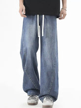 Men’s plus size vintage wide leg jeans in medium-wash denim with white drawstrings and a wide leg fit
