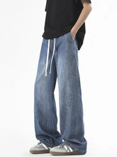 Men’s plus size wide leg jeans in light-wash denim with white drawstrings and visible stitching for vintage style