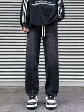 Men’s plus size black denim straight leg jeans with white drawstrings and relaxed wide-leg silhouette