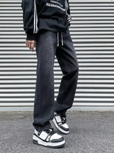 Men’s plus size black straight leg jeans with white drawstrings and subtle fading in denim material
