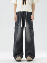 Men’s plus size dark-wash denim wide leg cargo jeans with white drawstrings and multiple flap pockets