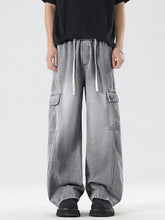 Men’s plus size wash wide leg cargo jeans in gray washed denim with white drawstrings and multiple flap pockets