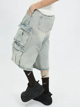 Men’s plus size washed light-wash denim cargo capris jeans with multiple flap pockets and a relaxed tapered fit