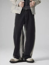 Men’s plus size black wide leg denim jeans with a faded distressed finish and visible stitching