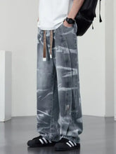 Men’s plus size washed wide-leg jeans in gray tie-dye denim with relaxed fit and brown drawstring waistband