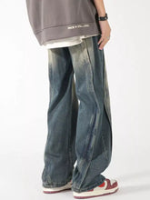 Men’s plus size washed wide leg jeans in faded denim with distressed details and visible side stitching