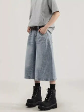 Men’s plus size wide leg capris jeans in light-wash denim with distressed details and visible stitching