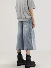 Men’s plus size wide leg capris jeans in light-wash denim with relaxed asymmetrical cut and visible stitching details