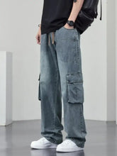 Men’s plus size wide leg cargo jeans in light-wash denim with multiple large pockets and a drawstring waistband
