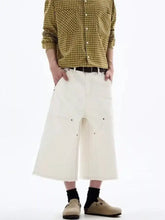 Mens plus size wide-leg cropped jeans in cream-colored denim with relaxed fit, frayed hem, and multiple pockets