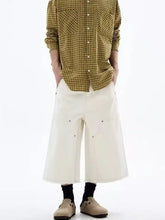 Mens plus size wide-leg cropped jeans in off-white denim with visible stitching and metal rivets at the pockets