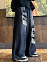 Men’s plus size wide leg dark blue denim jeans with distressed and frayed patches on the legs
