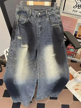 Men’s plus size wide leg distressed jeans in faded blue denim with high waist and ripped details