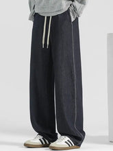 Men’s plus size wide leg denim trousers in dark wash with light gray drawstrings and stitched side seams