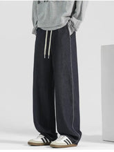 Men’s plus size wide leg dark-wash denim jeans with contrasting white stitching and light drawstring waistband