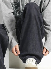 Men’s plus size wide leg drawstring jeans in dark indigo denim with light stitching and a relaxed tapered fit