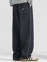 Back side of men’s plus size wide leg drawstring jeans in dark-wash denim with paper airplane embroidery and white stitching