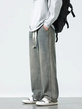 Men’s plus size wide leg jeans in gray washed denim with a loose fit and adjustable drawstring design