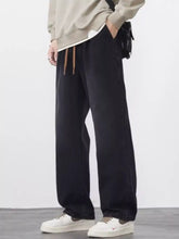 Men’s plus size wide leg jeans in black denim with tan drawstrings and a relaxed straight-cut silhouette