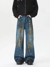 Men’s plus size wide leg jeans in faded blue and olive green denim with distressed paint splatter design