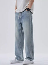 Men’s plus size light-wash denim wide leg jeans with relaxed straight leg cut and white drawstrings at the waist